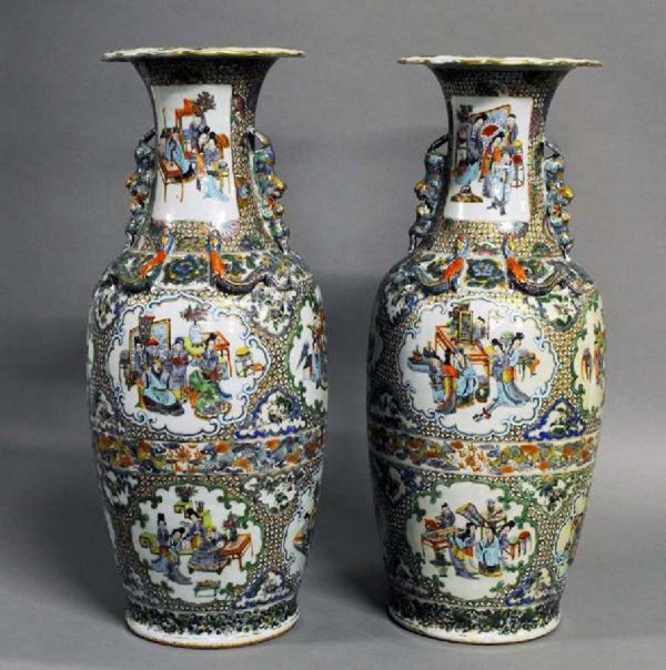 GOOD PAIR OF ROSE MEDALLION PORCELAIN VASES: Chinese. 19th Century. Each of ovoid form molded with fu lion handles and with dragons in high relief on the shoulder, painted with figural panels. Height 24 1/4". (Cond: each lip restored) (800/1200)