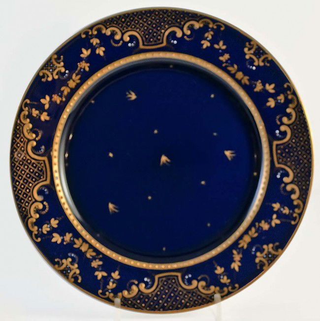 SET OF EIGHT VIENNA PORCELAIN DESSERT PLATES: Austrian. Circa 1915. Underglaze blue beehive mark, Austria and No. 95. Each cobalt blue with raised gilt enamel decoration. Diameter 8". (Cond: two with minute chip) (300/400)