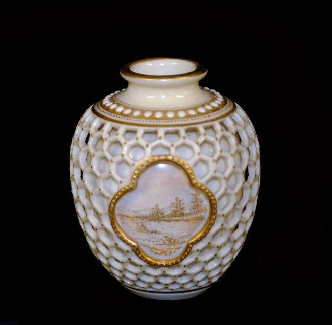 ROYAL WORCESTER BUD VASE: English. Late 19th Century. The small ovoid vessel with a double pierced wall and gilt landscape scenes. Height 3 1/4". (Cond: minor restoration) (100/150)