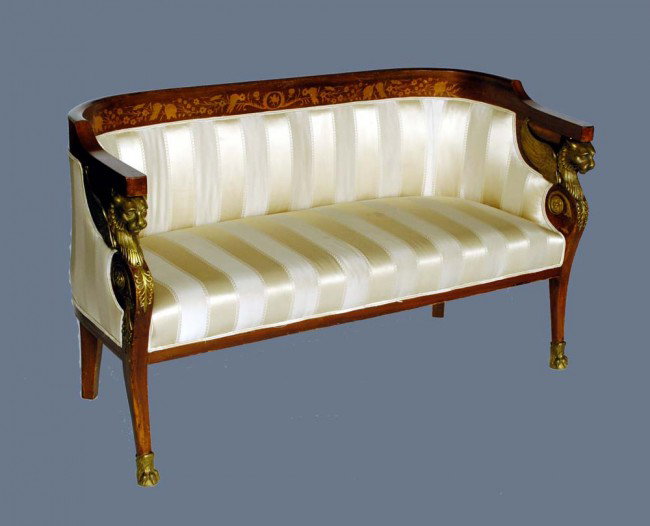 EMPIRE STYLE GILT BRONZE MNTD INLAID MAHOG CANAPE: French. The curved top rail with marquetry inlay above the padded back and seat flanked by winged lion arm terminals, raised on straight legs ending in hoofed feet. Length 59 1/4". (800/1200)