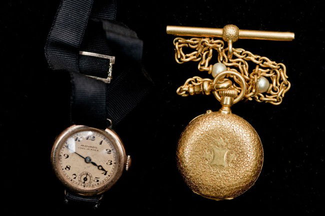 FOURTEEN KARAT YELLOW GOLD LADY'S PENDANT WATCH: With a hunter case, suspended from a gold fob chain. Together with a Movado gilt plated lady's wristwatch. (2 pcs) (150/200)