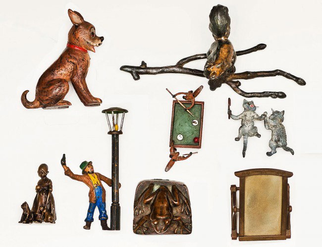 GROUP OF EIGHT MINIATURE SCULPTURES: European. Comprising: a Viennese cold painted group of cats, group of cats playing billiards, a seated dog, a toad, a squirrel on a branch, a drunk next to a lamppost, a small girl with a puppy and a 