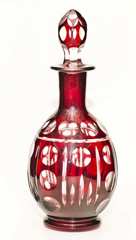 FOURTEEN PIECE RUBY OVERLAY GLASS LIQUEUR SET: Bohemian. 20th Century. Comprising: decanter and thirteen glasses. Each cut to clear with thumbprints. Together with seven ruby overlay shot glasses. (21 pcs) (150/200)