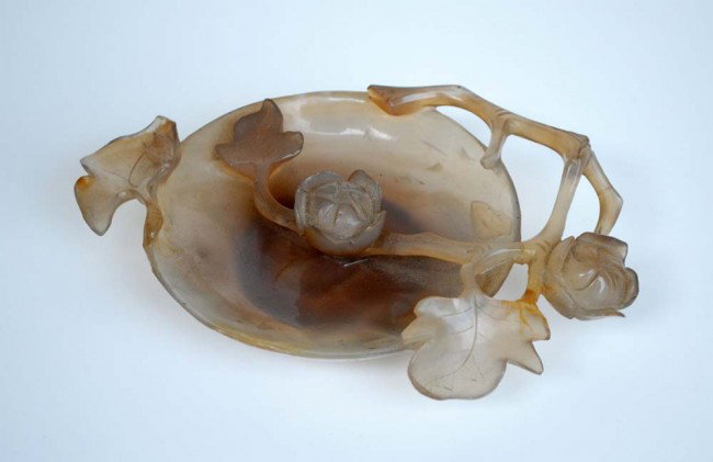 CARVED AGATE BRUSH WASHER: Chinese. The shallow bowl with blossoming branches and leaves in high relief. Length 6 7/8". (Cond: one branch restored) (200/300)