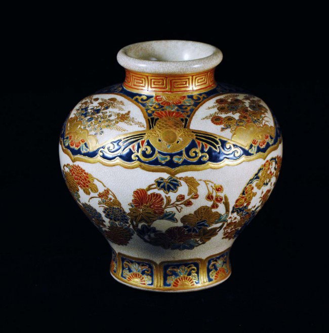 FINE SATSUMA POTTERY VASE: Japanese. Meiji-Period. 19th Century. Signed in gilt and with gilt Satsuma mon. Of squat baluster form decorated with fan shaped panels on the shoulder and raised gilt foliage. Height 5". (600/800)