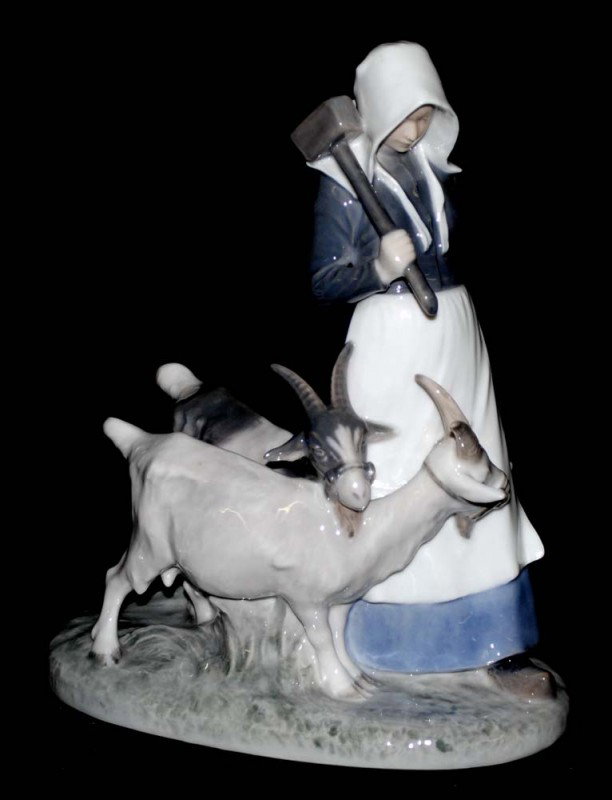 ROYAL COPENHAGEN PORCELAIN GROUP: Danish. Printed factory mark and Model No. 694. Of a peasant girl with two goats. Height 9 1/8". (250/350)