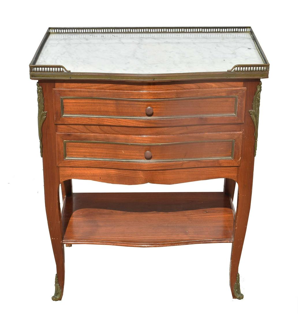 FRENCH MARBLE TOP MAHOGANY TABLE EN CHIFFONIER: The rectangular slightly serpentine white marble top within a three-quarter pierced brass gallery, the case with two drawers, above a shelf stretcher, on cabriole legs, with bronze chutes and sabots.