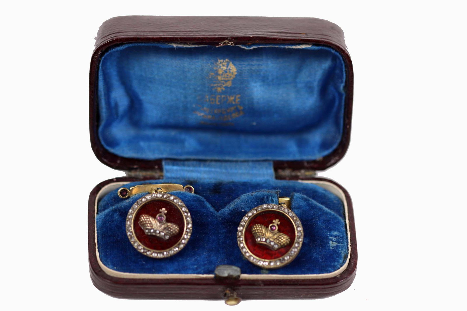 PAIR OF RUSSIAN ENAMEL & SILVER-GILT EARRINGS: Marked. Each red enameled circular face set with a gilt crown incorporating a ruby cabochon, headed by a cross, within a border of diamond chips, the gilt fastener with diamonds.
