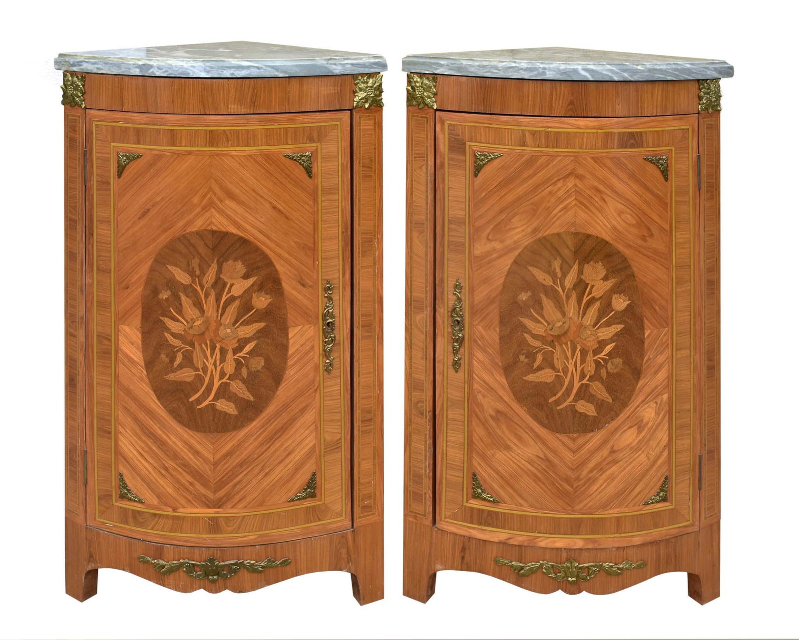 PR LOUIS XVI STYLE TULIPWOOD MARQUETRY CORNER CABINETS: Each with a marble top above a cabinet door, with center foliate inlaid roundel above a shaped skirt, on plain legs, with gilt bronze mounts. Height 36.5 in. Width 20 in. Depth 13.5 in.