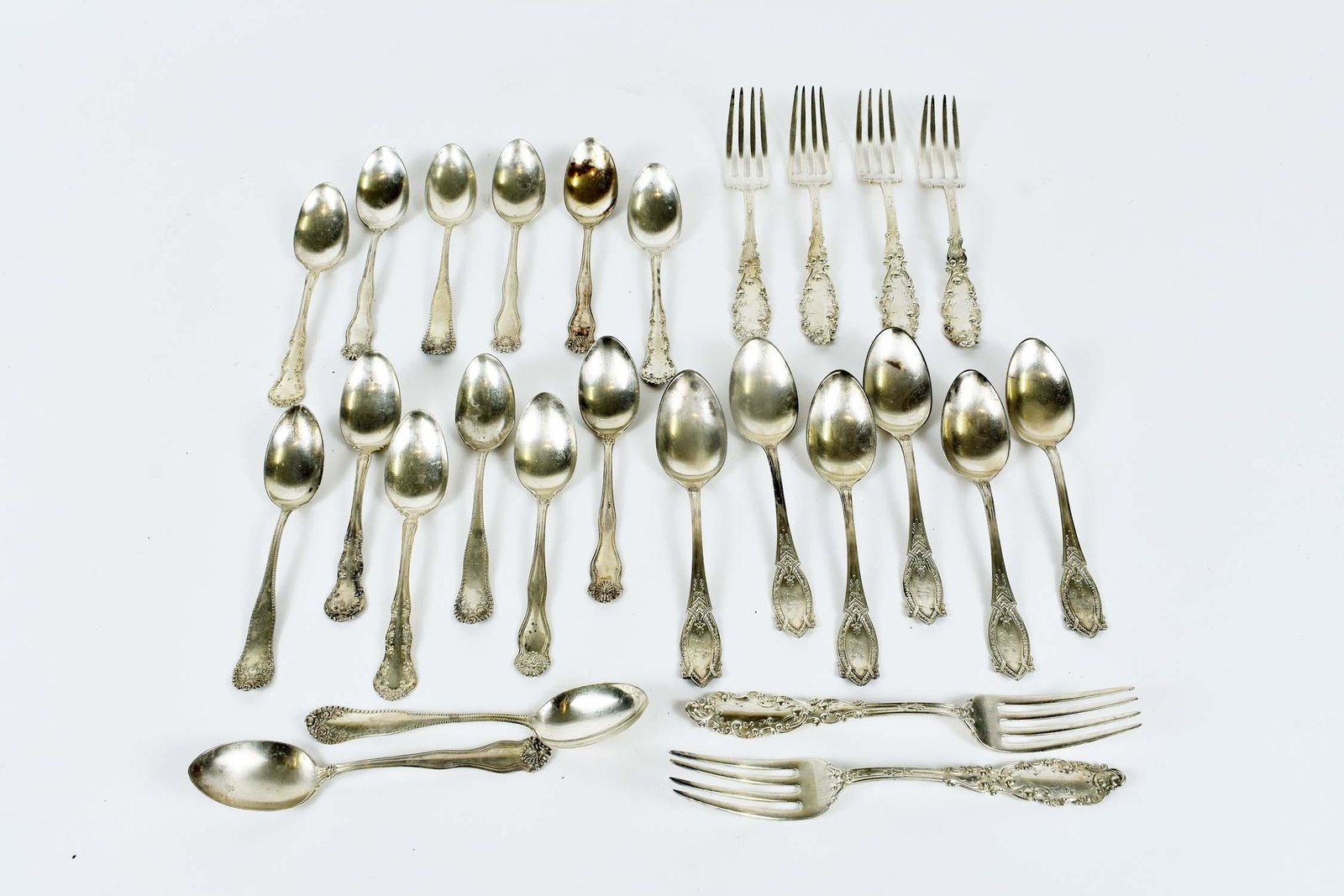TWENTY-SIX MISC. STERLING SILVER FORKS & SPOONS: Late 19th/early 20th Century. Comprising: four Gorham teaspoons, four further American teaspoons, six Continental monogrammed spoons teaspoons, six Wallace & Sons teaspoons and six J.B. Storrer & Co.