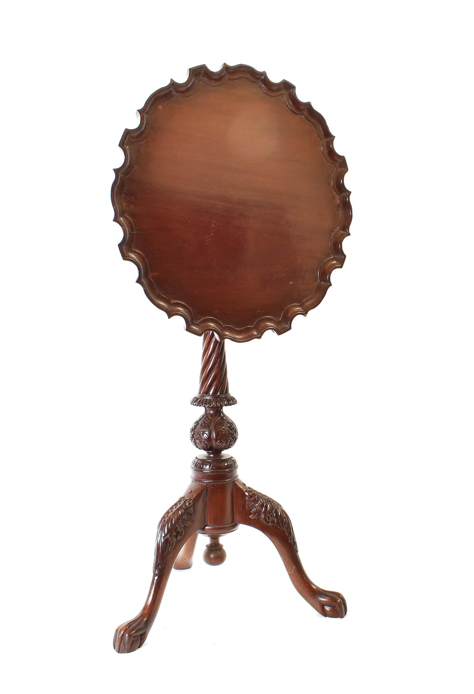 GEORGE III STYLE MAHOGANY TILT-TOP TRIPOD TABLE: The circular top with a pie-crust edge, above a foliate spherical carved columnar shaft, atop tripod legs, ending in claw-and-ball feet. Height 27 in. Diameter 17.5 in.
