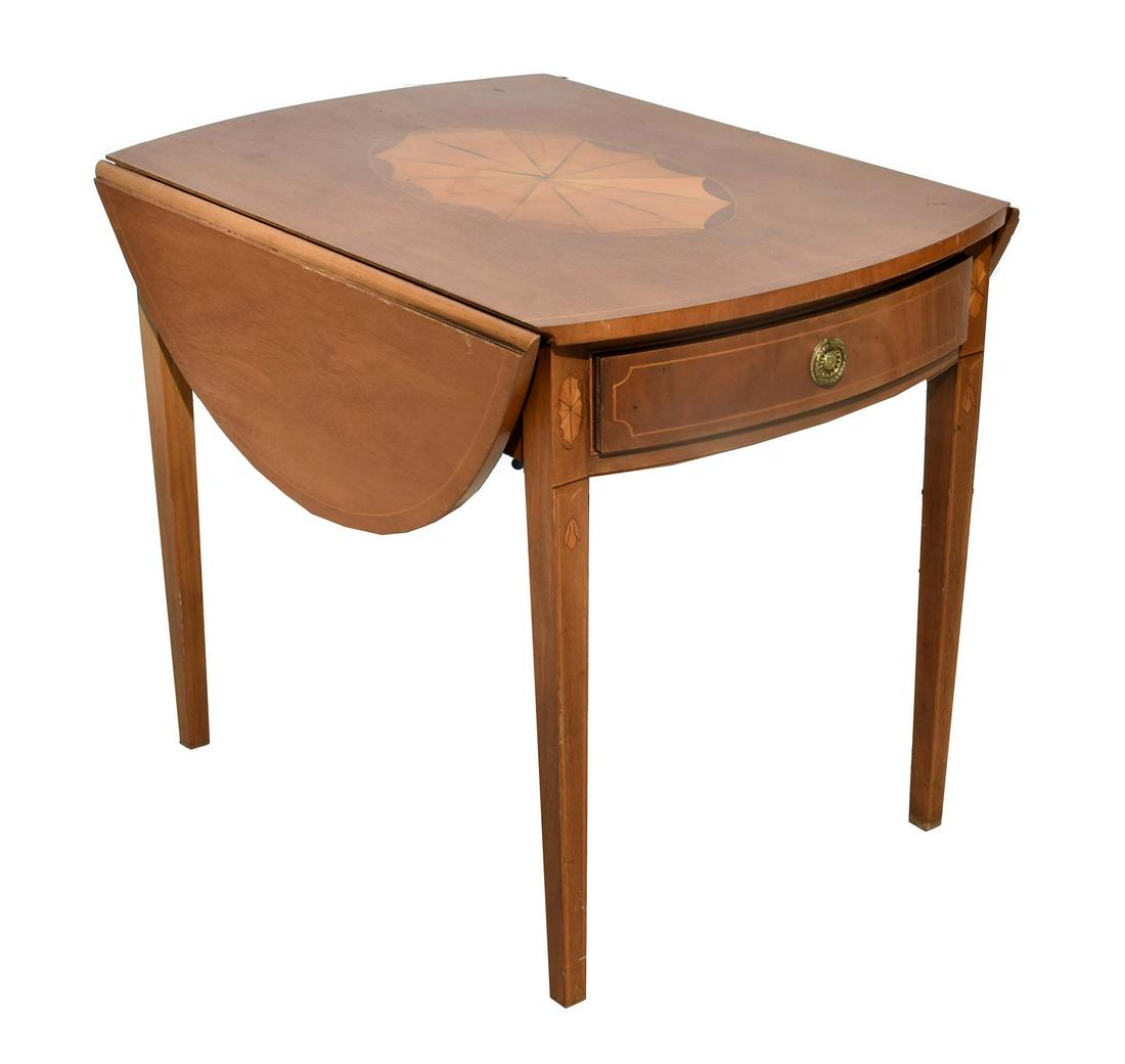 GEORGE II STYLE INLAID MAHOGANY PEMBROKE TABLE: The rectangular top with rounded ends inlaid with a fruitwood patera, the frieze with a drawer, flanked by D-shaped flaps, on straight tapered legs. Height 25 in. Width 30 in. Depth 21 in.
