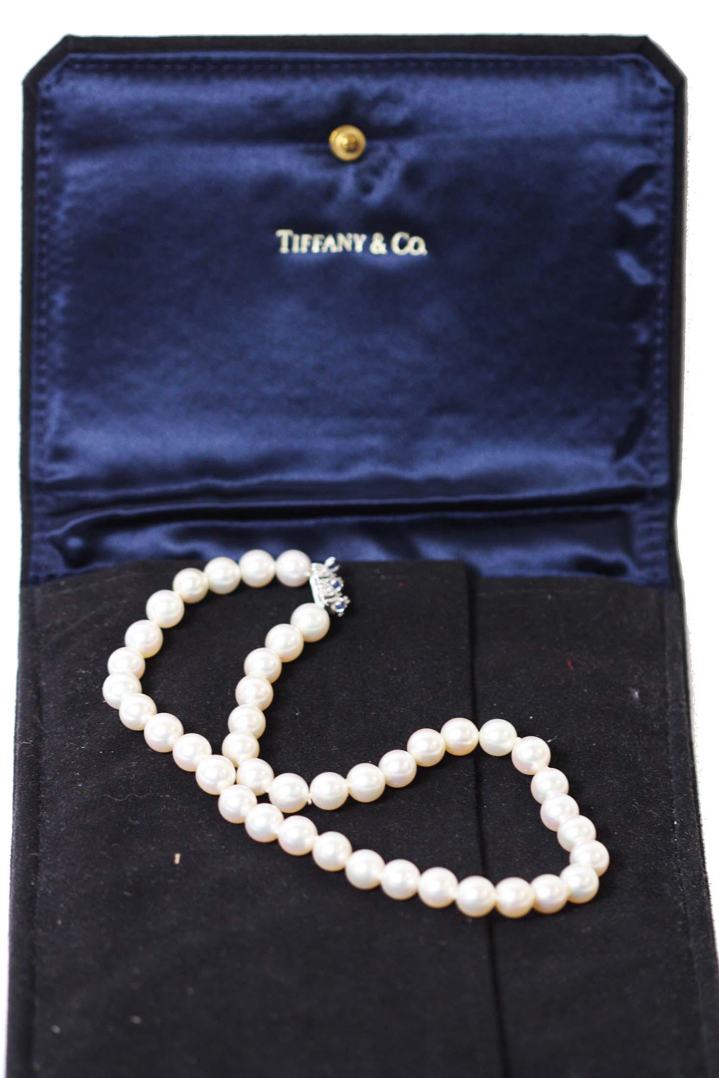LADIES' TIFFANY PEARL CHOKER: Marked Tiffany & Co. France 18KT. The Japanese Akoya 8.5mm pearls with together with an 18KT. white gold clasp set with diamond chips and three sapphire points. With a suede Tiffany case.
