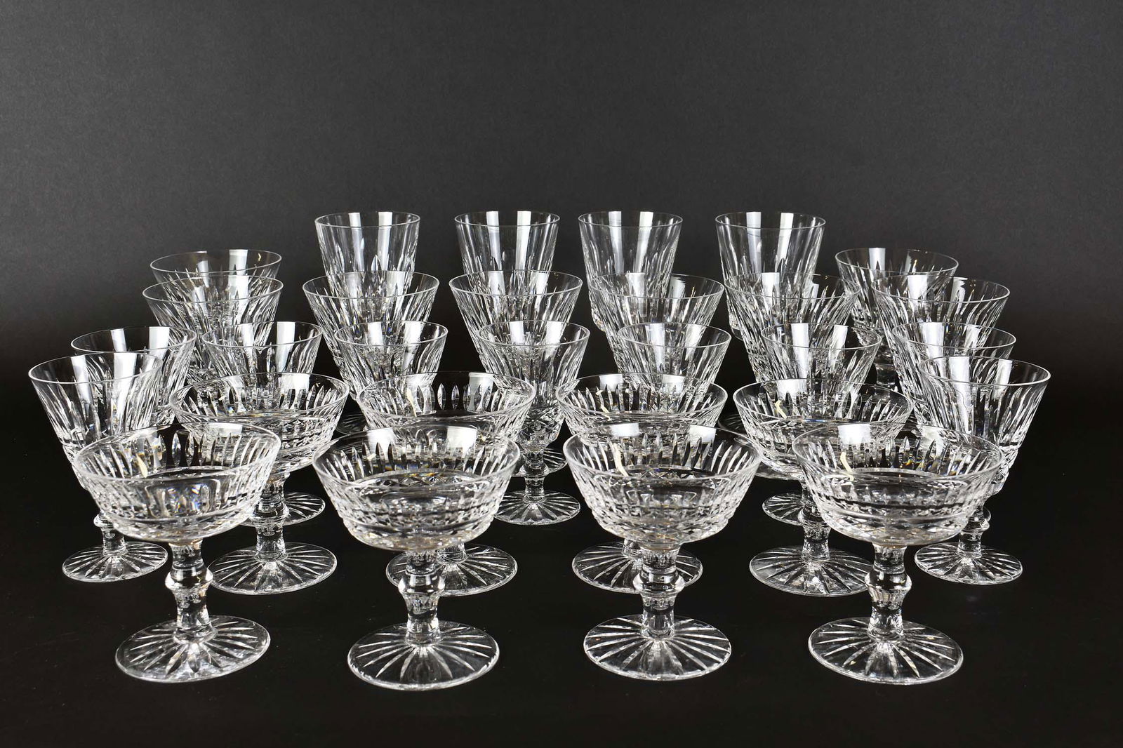 WATERFORD CRYSTAL STEMWARE SERVICE (29 pcs.): The undersides marked. Comprising: four water goblets, eight red wines, nine white wines, and eight champagnes. Height of goblets 7 in. Height of white wines 5 in.