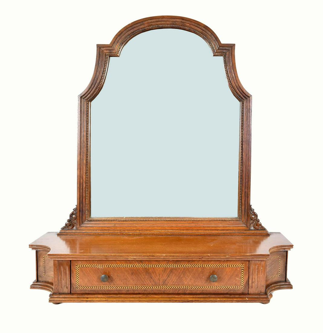 GEORGE III STYLE INLAID MAHOGANY DRESSING MIRROR: The arch mirror plate pivoting on scroll and leaf carved supports, the shaped lower part with an inlaid drawer, on top-form feet. Height 26 in. Width 24 in. Depth 8 in.
