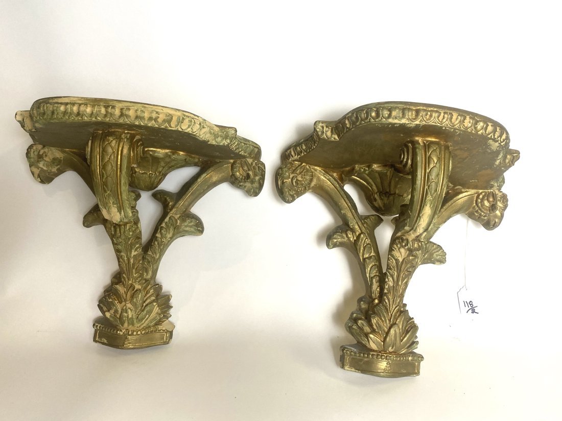 PAIR OF CARVED AND GILT COMPOSITION BRACKETS.: Early 20th Century. In Rococo Style, each shaped shelf on three scro0lled supports, carved with leaves. Heighrt 12 in. (approx)