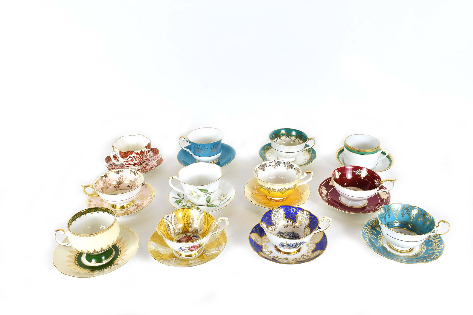 GROUP OF TWELVE ENGLISH PORCELAIN TEACUPS: Various factories, all marked. Many with hand painted foliage, some in a neoclassical design, others with gilt highlights. Sizes vary.