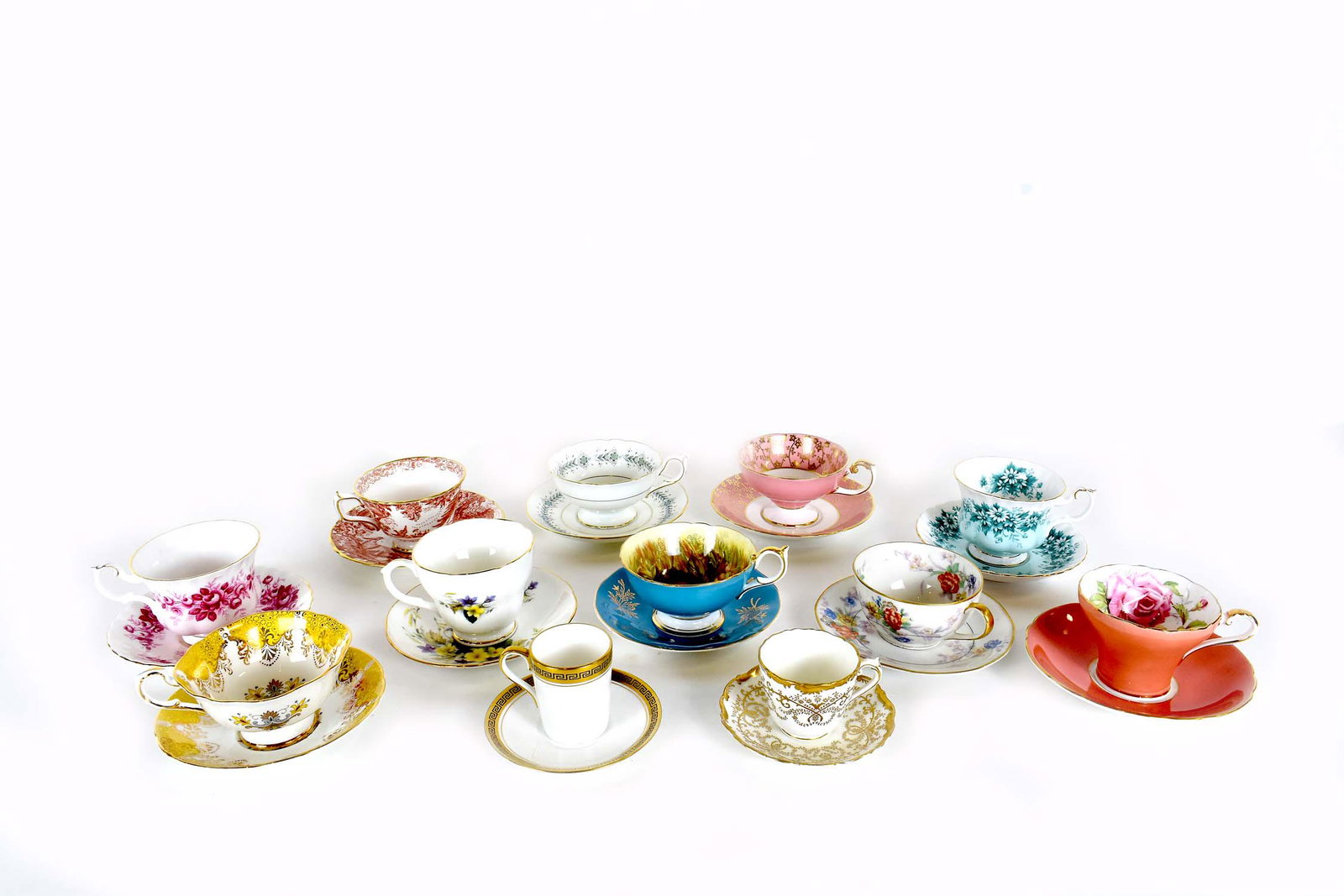 GROUP OF 12 ENGLISH PORCELAIN TEACUPS WITH SAUCERS: Various factories, all marked. Including examples with hand painted foliage, some having scrolling motifs, others with neoclassical and some with gilt highlights. Sizes vary.