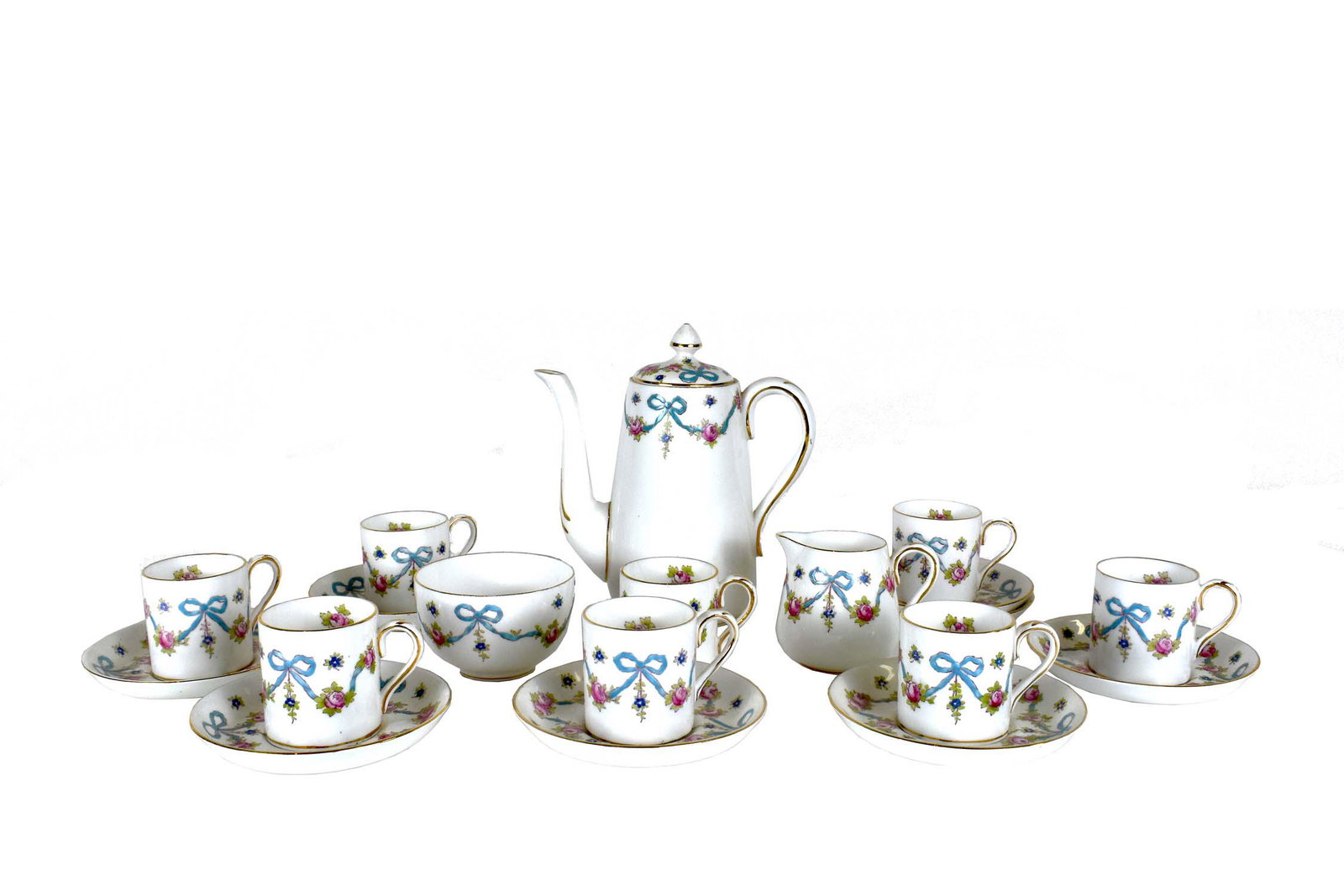 ENGLISH CROWN STAFFORDSHIRE COFFEE SERVICE: Marked. Comprising a coffee pot, sugar bowl, creamer, and eight coffee mugs with saucers. Decorated with colorful floral garlands. Height of coffee pot 8 in.
