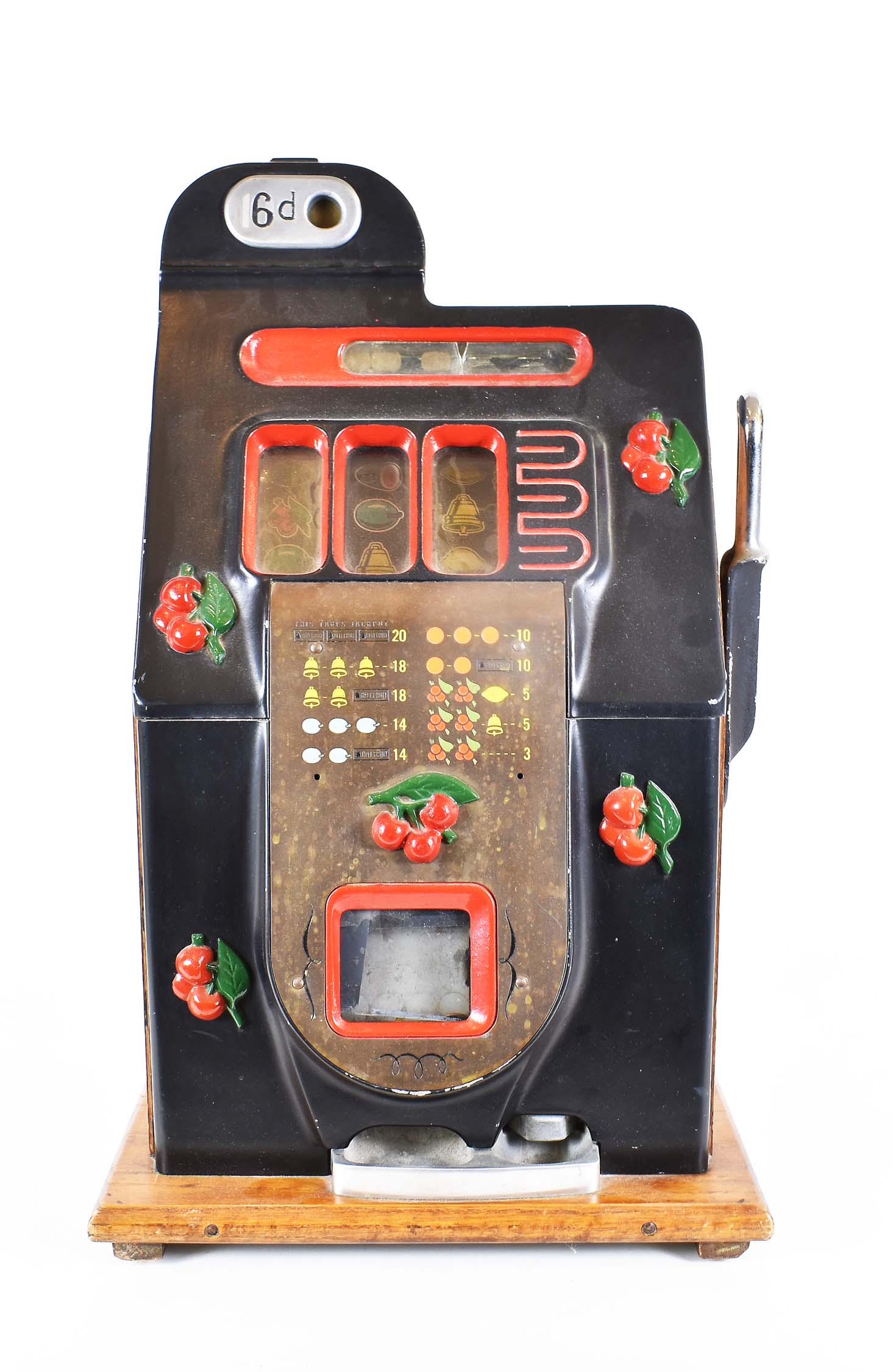 ANTIQUE EUROPEAN SLOT MACHINE: Circa 1900 to 1920. Bearing a branded serial number on the wood base. The painted cast iron and oak case with a pull leaver, the rotating wheels with fruit, bars and bells. Height 26 in. Width 14.75 i