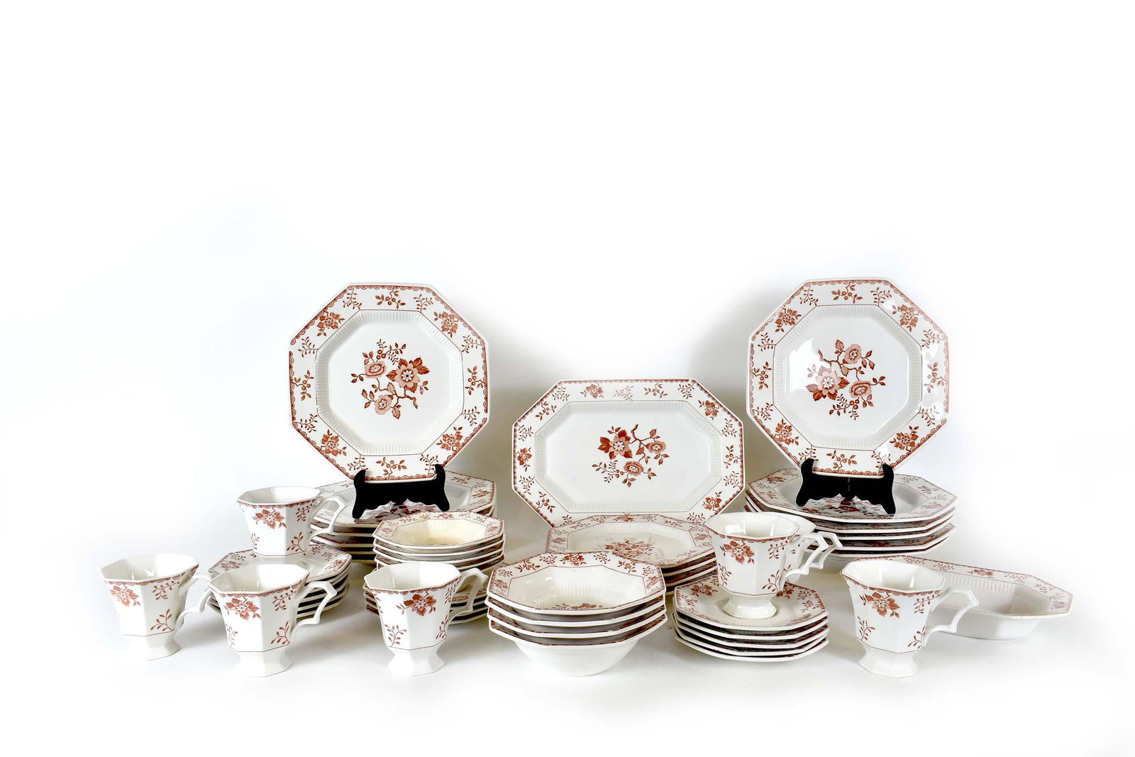 JAPANESE EARTHENWARE PART DINNER SERVICE: The underside of each marked NIKKO, Classic Collection. Each of the forty-nine pieces of octagonal-shaped items decorated with floral sprays in burnt umber. Comprising: a rectangular platter, a servin