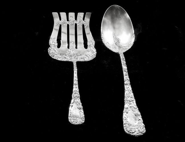 TWO STERLING SILVER FLATWARE PIECES: American. Circa 1895. Maker: Durgin. In the "Chrysanthemum" pattern. Comprising: stuffing spoon and large cold meat fork. (12 oz) (Fork with monogrammed handle) (500/600)