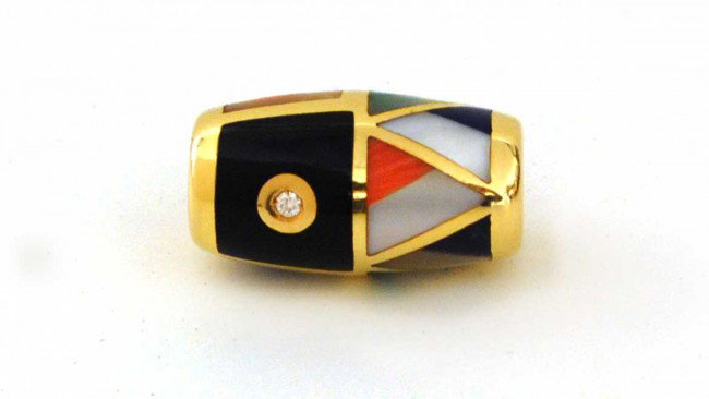 ASCH & GROSSBARDT FOURTEEN KARAT YELLOW GOLD SLIDE: Signed. Of barrel form, set with two diamonds and various colored stones. (200/300)