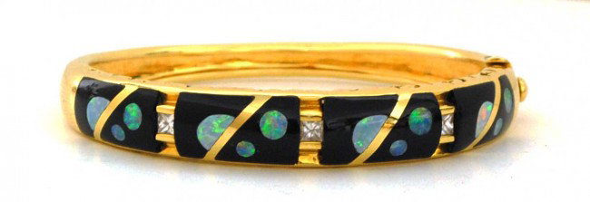 ASCH & GROSSBARDT FOURTEEN KT YELLOW GOLD BANGLE: Signed. With four onyx panels divided by a diamond and inlaid with opal. (1000/1500)