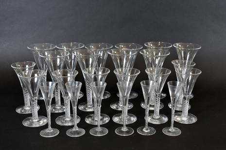 VENETIAN COLORLESS GLASS PART STEMWARE SERVICE: Modern. Each of the twenty-four glasses with a flared bowl on latticinio twist stems with a circular foot. Comprising: ten red wines, eight white wines and six cordials. Heights 7.75 in., 6.5