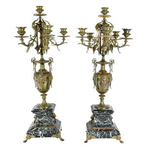 PAIR OF NAPOLEON III BRONZE & MARBLE SIX-LIGHT CANDELABRA: Late 19th Century. The mask-mounted urn form standard atop a stepped marble plinth, with bronze paw feet, the upper scrolled candelabrum with palmettes. Height 30 in. Width across candelabrum 12 in.