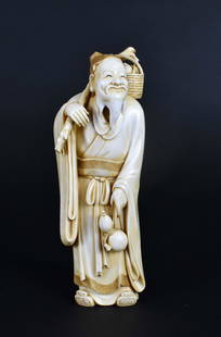 FINE CHINESE ELDERLY MAN: 19th Century. The underside signed with two carved characters. The bearded old man with a branch on his shoulder supporting a basket of fruit, with a double gourd tied to his waist, the carving