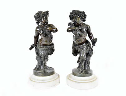 PAIR OF CLODION PATINATED BRONZE SATYR SCULPTURES: French. Late 19th/early 20th Century. After models by Claude-Michel Clodion. Each young playful satyr atop a stump, holding a thyrsus and bird, on a circular base, atop a white marble circular 