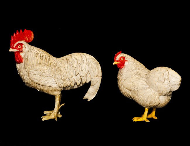 CARVED AND POLYCHROMED IVORY CHICKEN AND ROOSTER: Japanese. Each in a standing position. Heights 4 1/2" by 3 3/8". (Cond: rooster cracked, losses and restored) (250/350) NOTE: This lot is being re-offered for sale due to the fact that Mr. Peng Zhao o