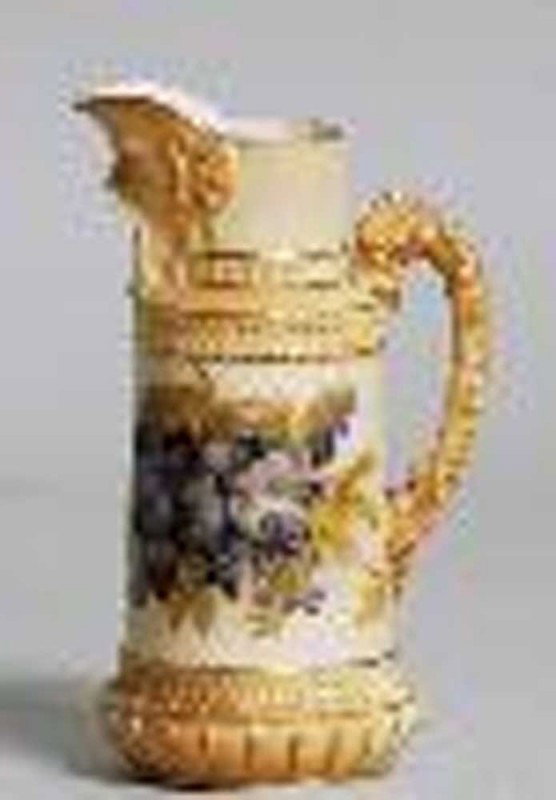 ROYAL WORCESTER PORCELAIN JUG: English. Late 19th Century. Model No. 1366. Molded with a mask form spout and painted with flowers. Height 6 3/8".