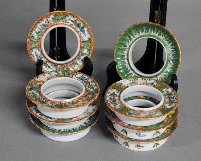 GROUP OF EIGHT PORCELAIN TEA CUP STANDS: Chinese. 19th Century. Comprising: four rose medallion, two famille rose and two famille verte. Each circular stand with scalloped edge. Diameter 4 1/8". (Cond: chips)