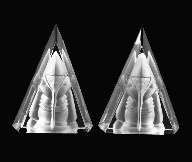 PAIR OF DAUM FROSTED AND CLEAR CRYSTAL TRIANGLES: French. Initialed D. Each back cut with a figure of an alien. Height 4".