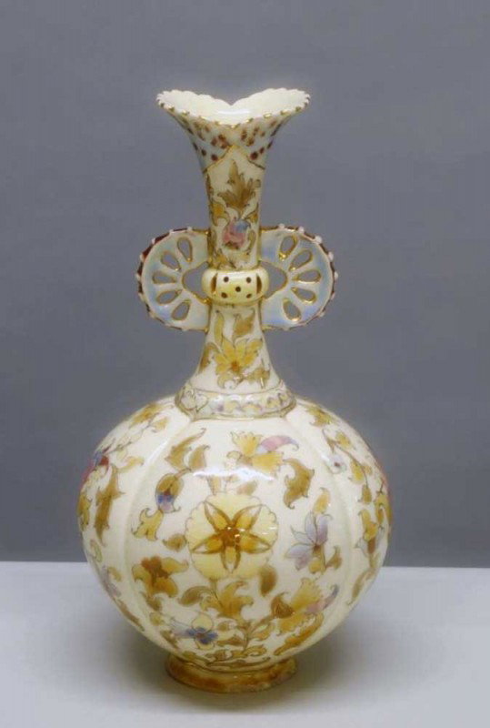 ZSOLNAY (PECS) FAIENCE VASE: Hungarian. 20th Century. Blue Castle factory mark. Of bottle form with reticulated handles, painted with flowers. Height 10".