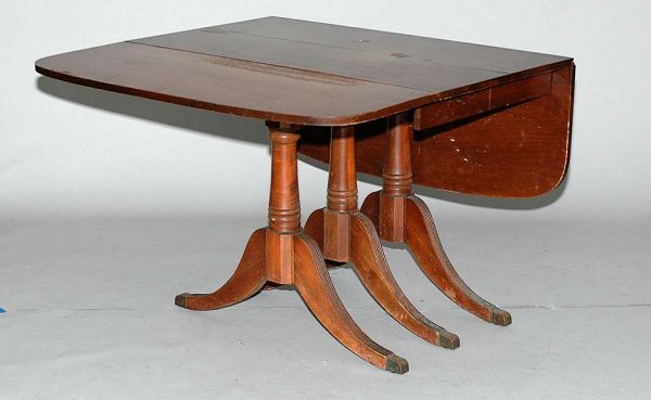 Drop Leaf Mahogany Dinning Table with Two Leaves: Drop Leaf Mahogany Dinning Table with Two Leaves. Duncan Phyfe Style D-end Table Over Three Supports with Splayed Feet Terminating in Brass Caps. Measures 30 Inches Tall 42 Inches Wide 24 Inches Deep.