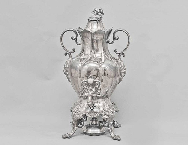 VICTORIAN SYTLE SILVER PLATED TEA URN AND COVER: With twin handles, pierced base and scroll feet. Height 15 7/8". (150/200)