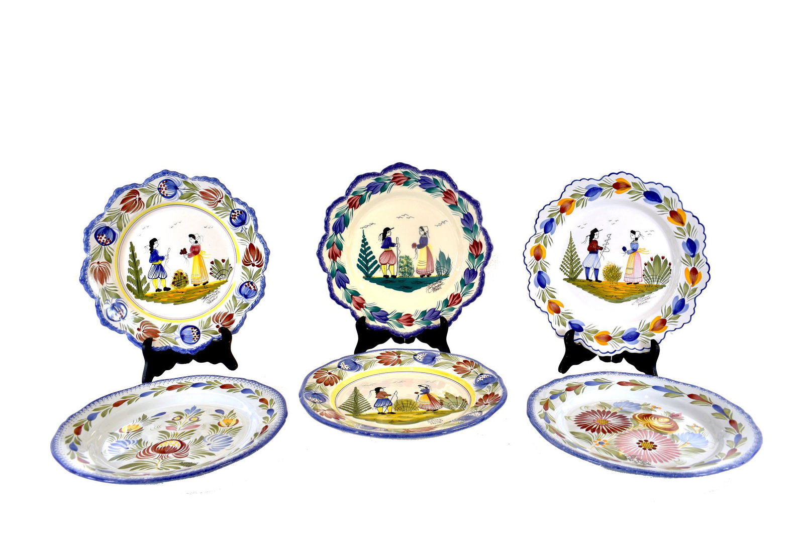 EIGHT VINTAGE QUIMPER EARTHENWARE PLATES: French. Each variously marked. Painted with couples, a male or female figure, with varied foliate borders.