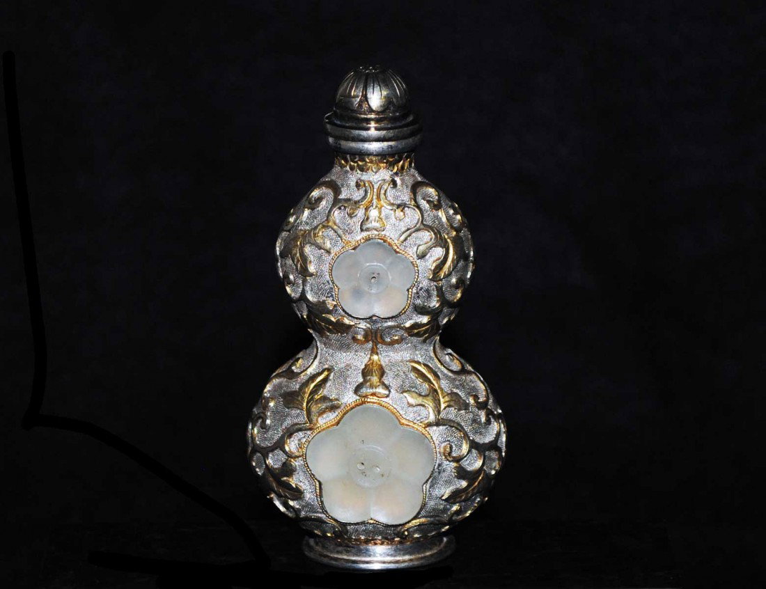 MONGOLIAN SILVER AND JADE SNUFF BOTTLE: Signed. Of flattened double gourd shape with gilt highlights. Height 3 1/2". (500/700)