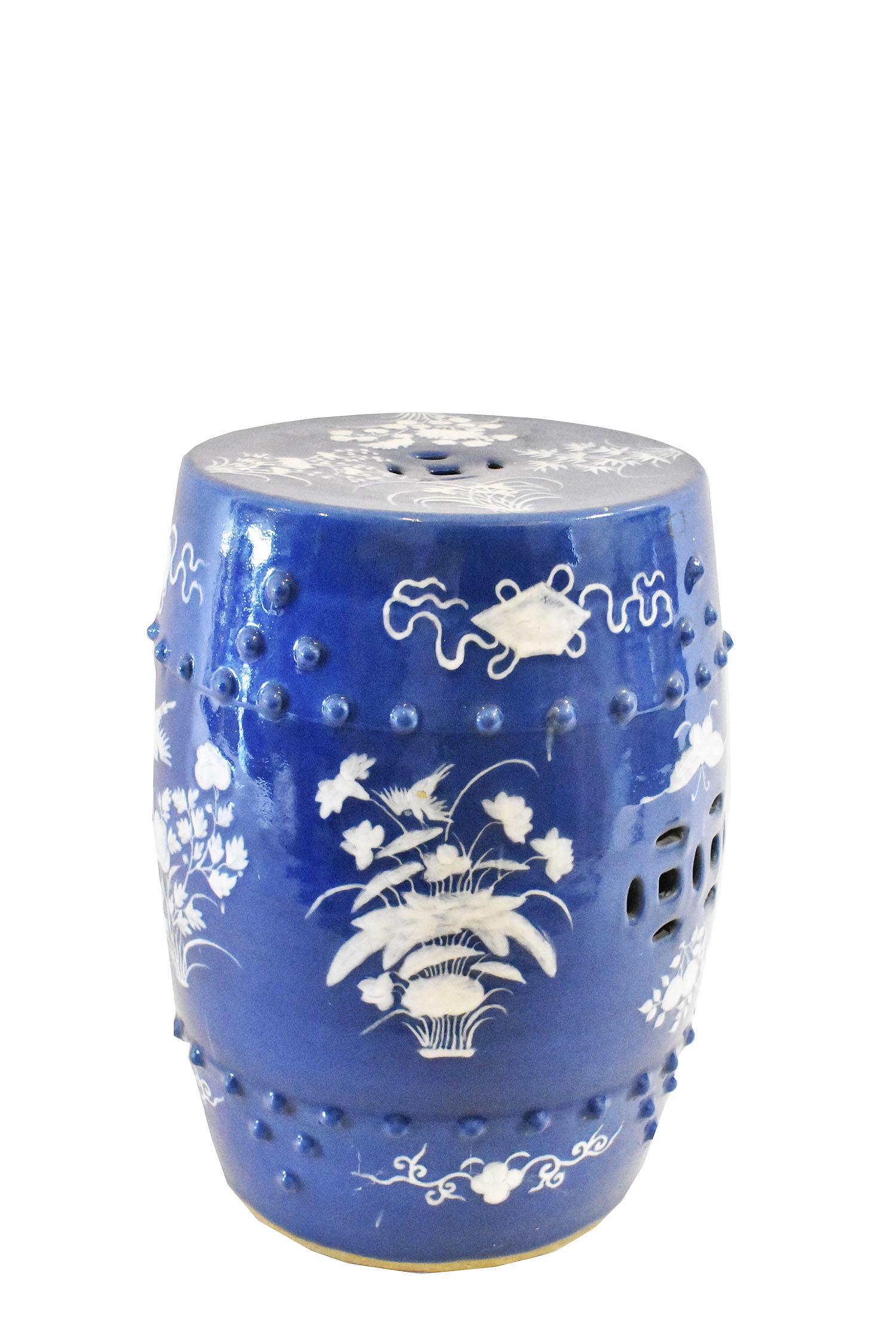 CHINESE SLIP-DECORATED PORCELAIN GARDEN SEAT: 20th Century. Decorated with textured white slip to depict birds amidst foliage with antique symbols within an upper and lower raised bead border, on a powder blue ground. Height 19 in. Diameter 12.5 