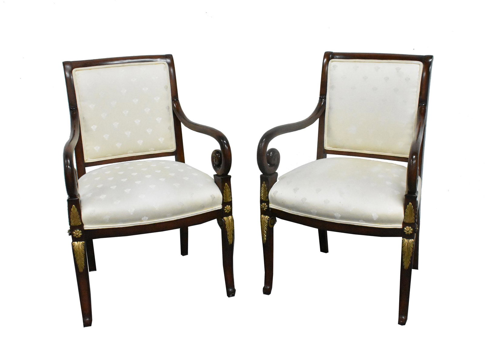 PAIR OF FRENCH RESTORATION STYLE MAHOGANY ARMCHAIRS: The square backs with downward scrolled arms, on forward curved saber legs, with carved gilt leaves. Height back to floor 35 in. Width of seat 22 in. Depth of seat 19 in.