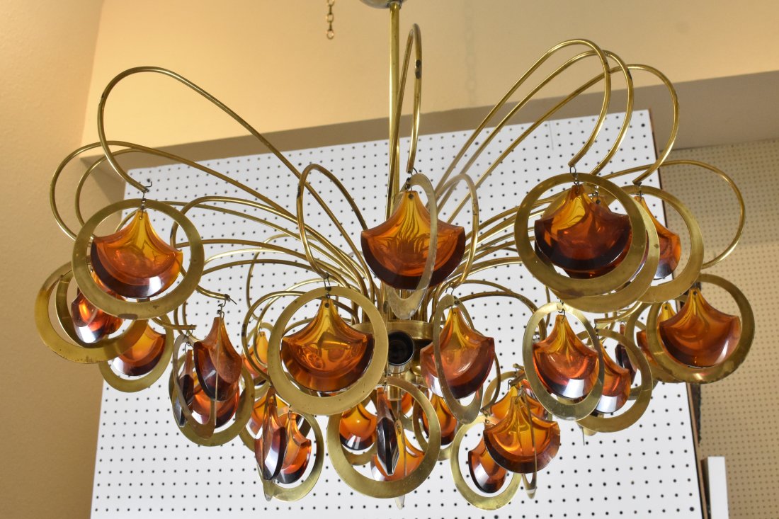 CONTEMPORARY BRASS & GLASS SIX LIGHT CHANDELIER: The whole with curved brass arms suspending amber colored glass pendants. Height 14 in. Diameter 24 in. (approx)