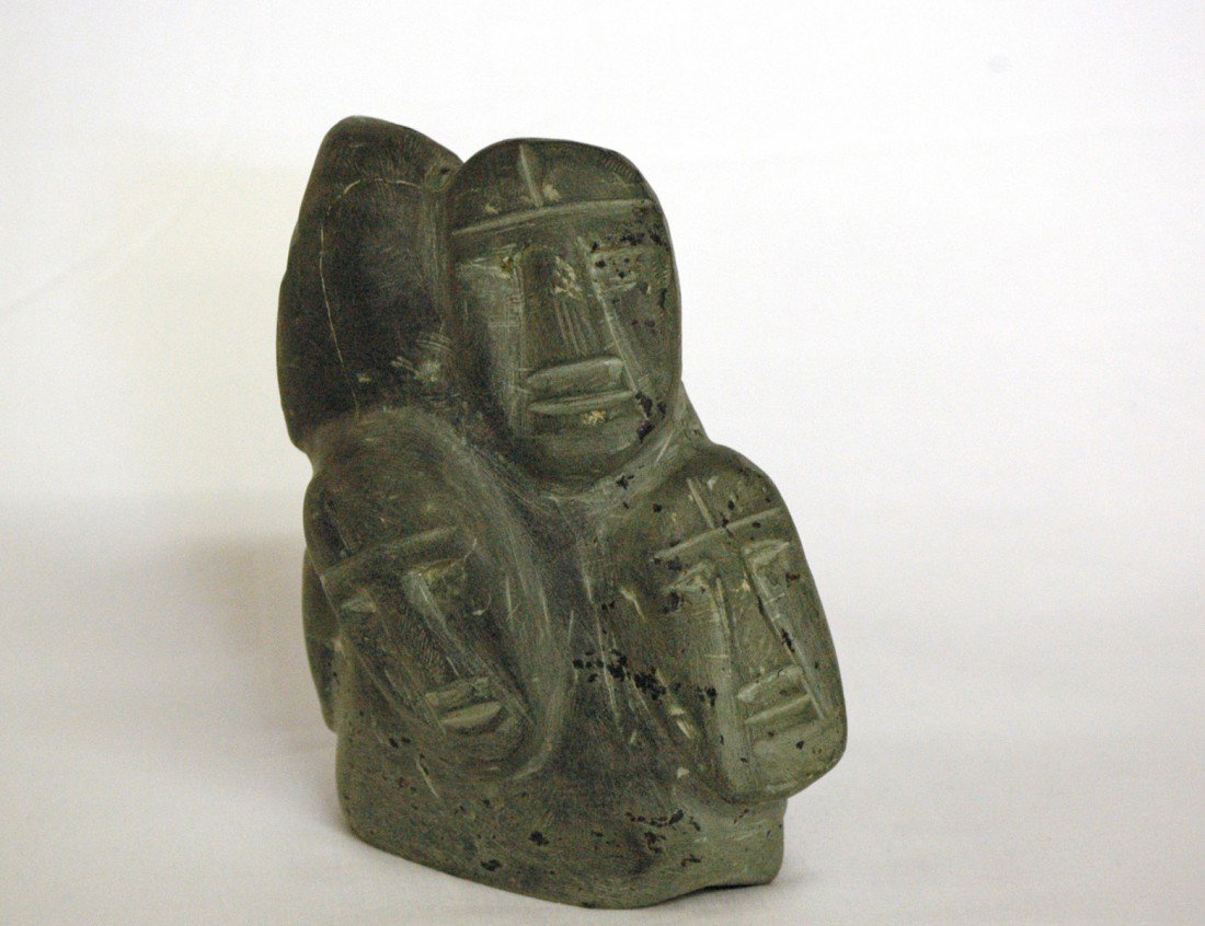 CARVED STONE BOULDER OF FACES: Inuit. Arviat/Eskimo Point, 1992. By Luke Hallauk. Height 6". With original Canadian government certificate. (300/400)