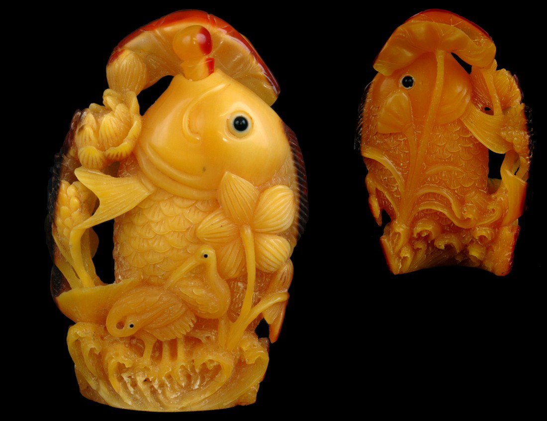CARVED HORNBILL SNUFF BOTTLE: Chinese. Carved as a giant carp emerging from the water among water plants and wading birds. Height 2 3/4". (600/800)