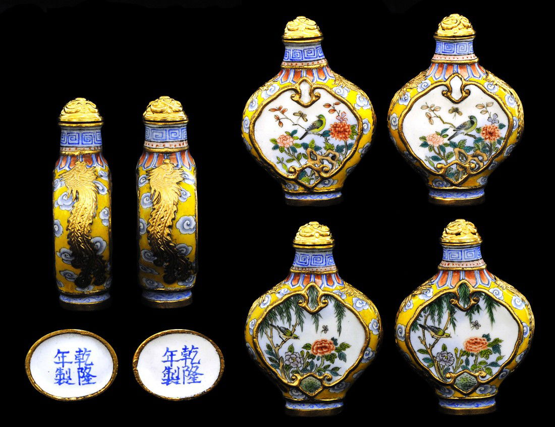 PAIR OF ENAMEL SNUFF BOTTLES: Chinese. Signed with four character mark. Each of flattened form with floral panels and gilt archaic fish design on the shoulders. Height 2 7/8". (600/800)