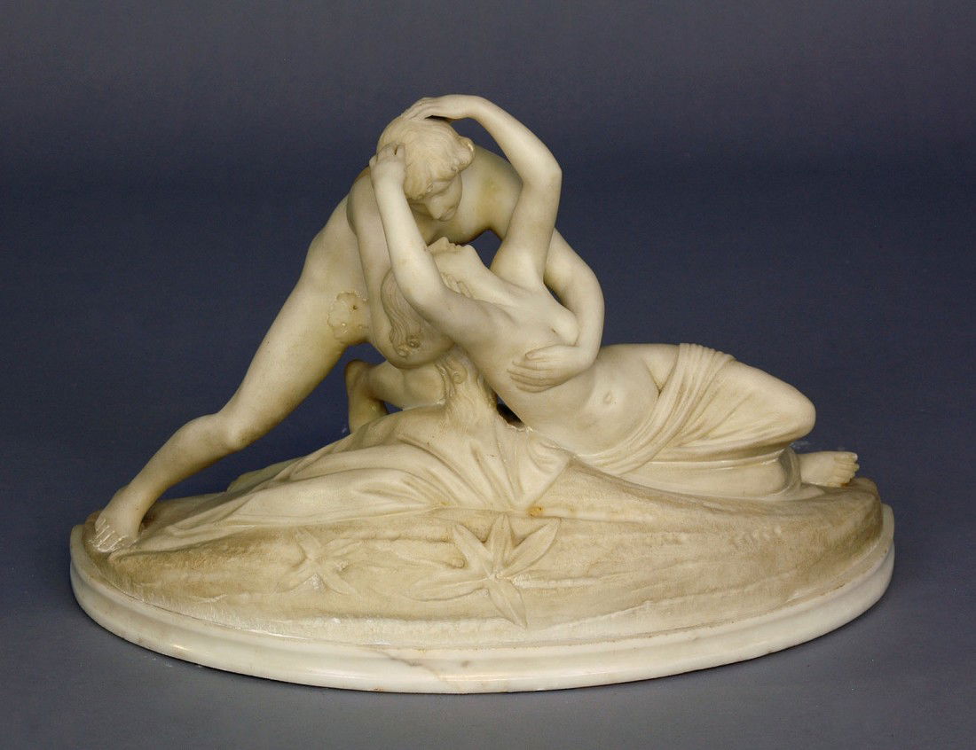 CARVED ALABASTER GROUP: Italian. Of Cupid cradling a semi-naked Psyche. Height 13 1/4". Length 21 3/4". (Cond: Cupid's wings missing) (300/400)
