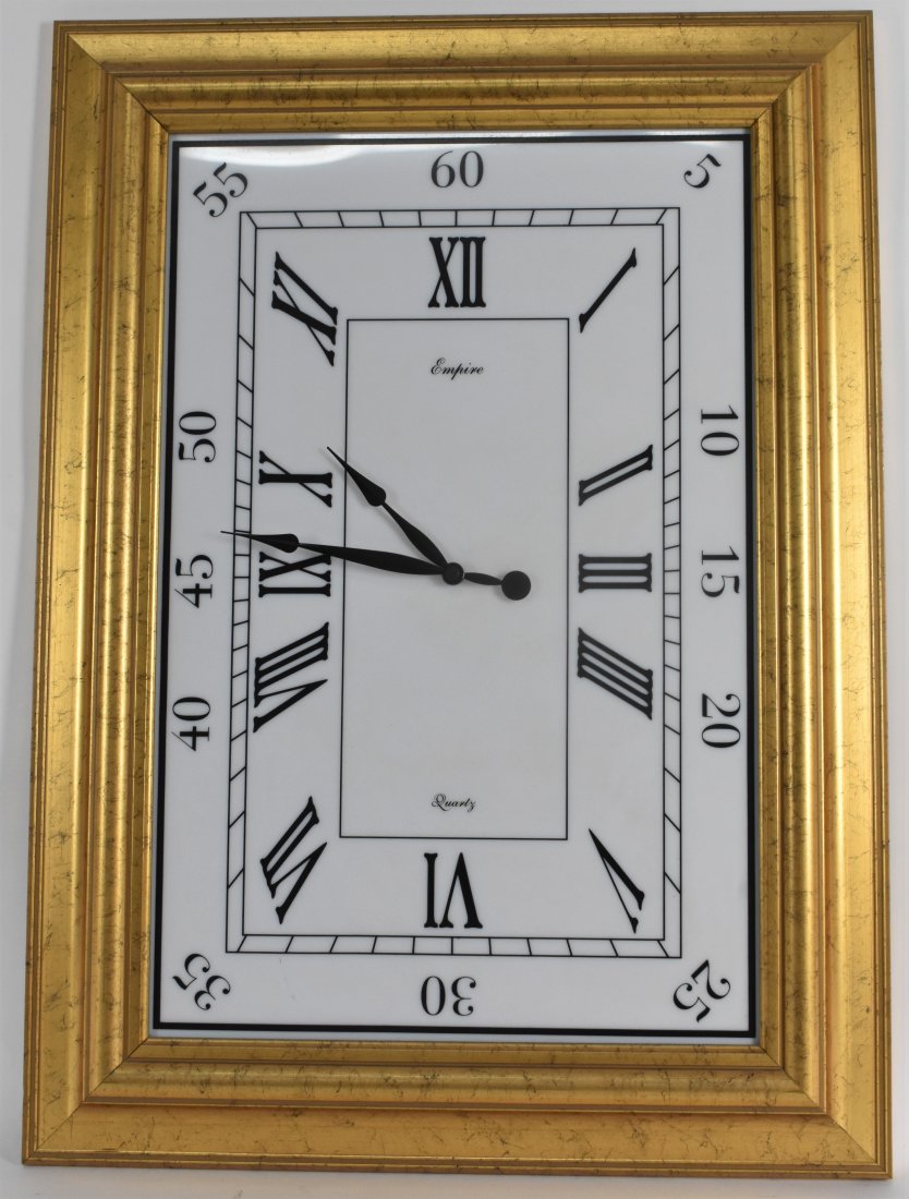 CONTEMPORARY QUARTZ CLOCK: Rectangular, with Roman numerals on a white dial, in a giltwood frame. Overall 30 by 21.75 in.