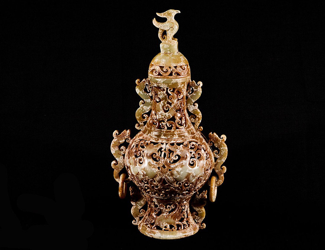 PIERCED CARVED SOAPSTONE VASE AND COVER: Chinese. The fully reticulated vessel with kylin loose ring handles, the whole with dragon design. Height 12 1/2". (250/350)